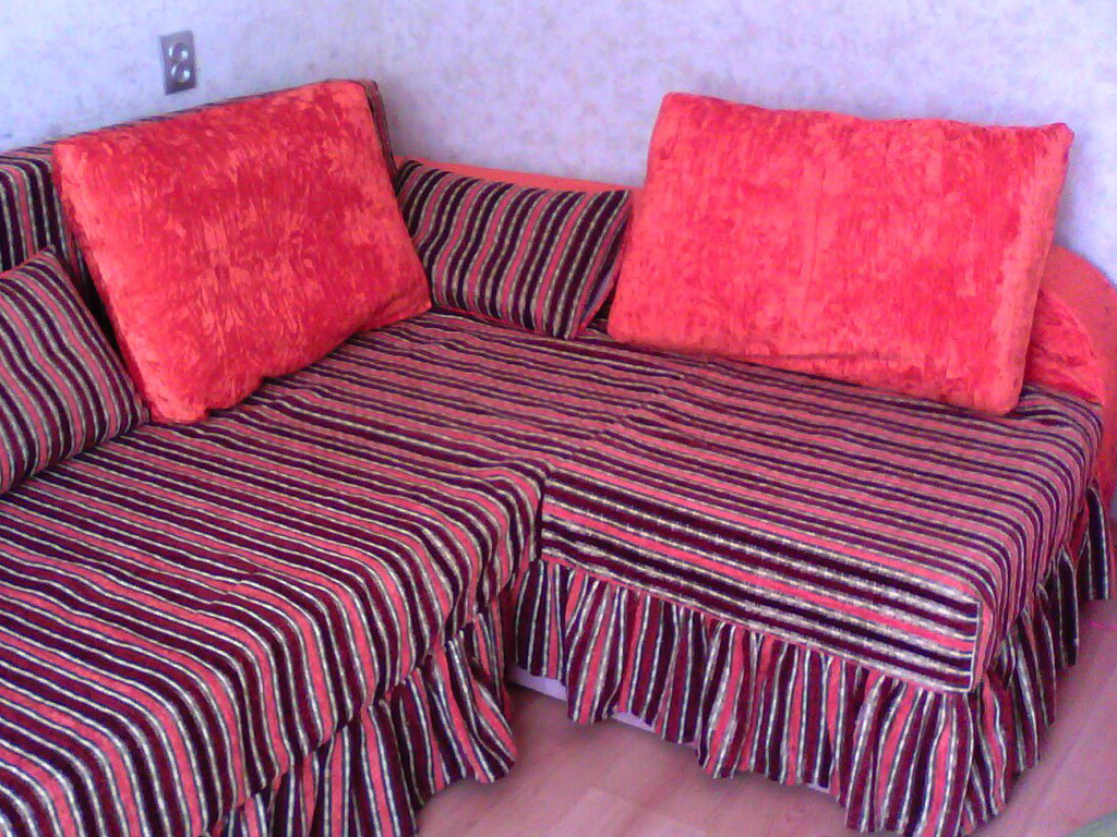 Розовый диван с большими подушками
